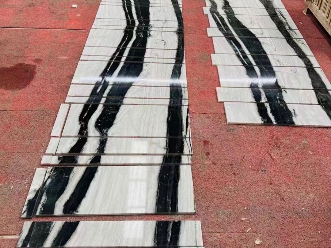Long Panda White marble strips dry-laid in two groups to check vein continuity