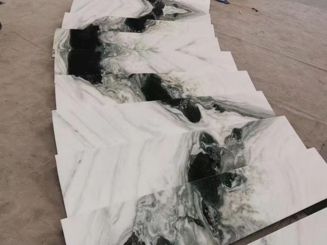 Panda White marble stair treads dry-laid in sequence with continuous black and gray veining